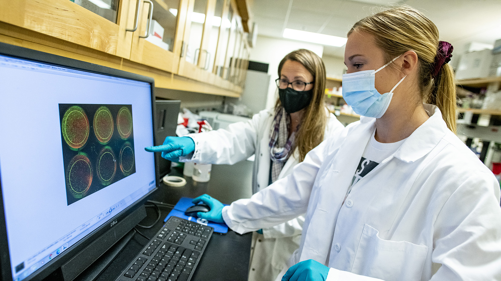 Student Amanda Sandberg (from Sweden) works with her Associate Professor of Microbiology instructor Melissa Maginnis in their Hitchner Hall lab.