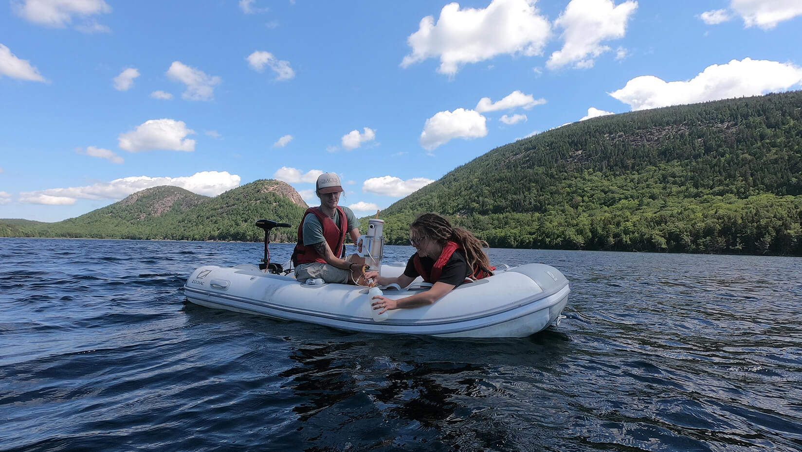 Graduate students Matt Faragher and Vendy Hazukova take a water sample from Jordan Pond. Photo by Credit C. Schmitt/Schoodic Institute