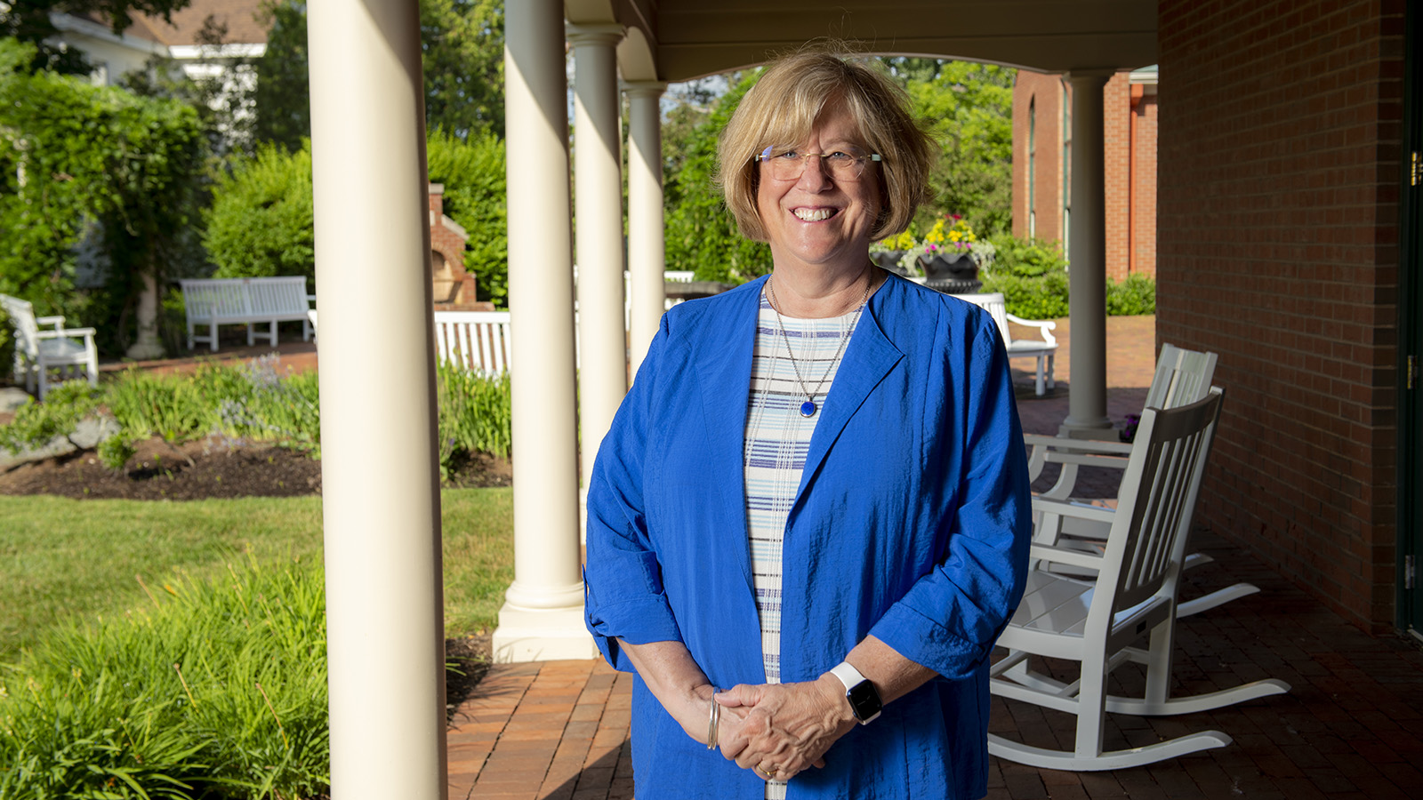 Photo of President Joan Ferrini-Mundy outside Buchanan Alumni House on the University of Maine campus