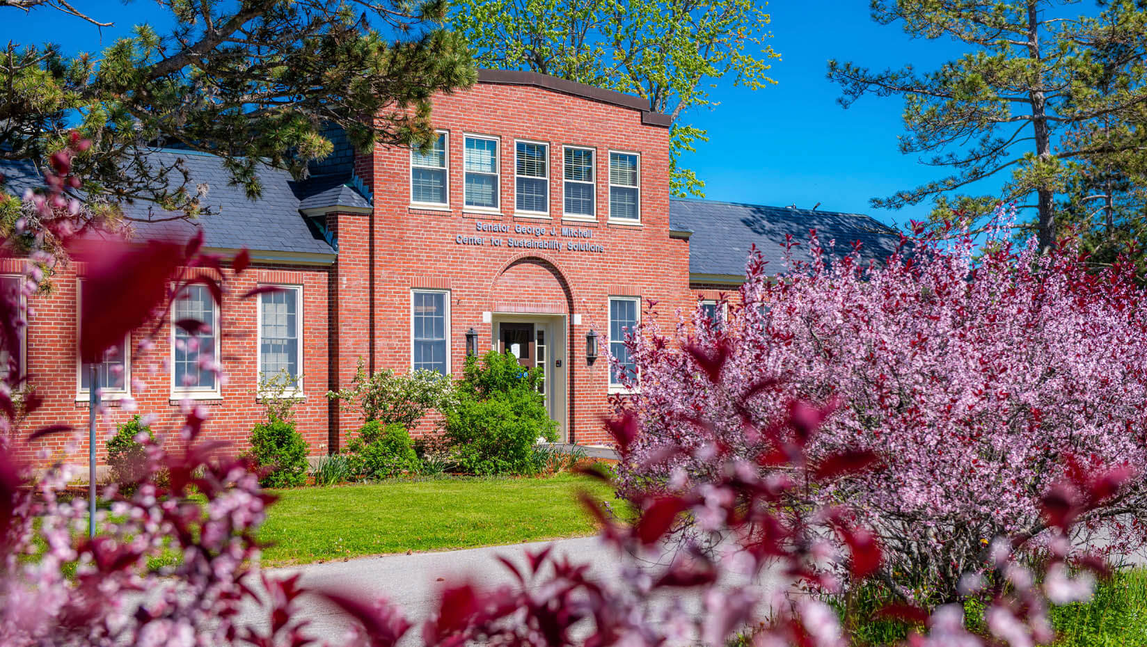 A photo of a brick building on campus in spring