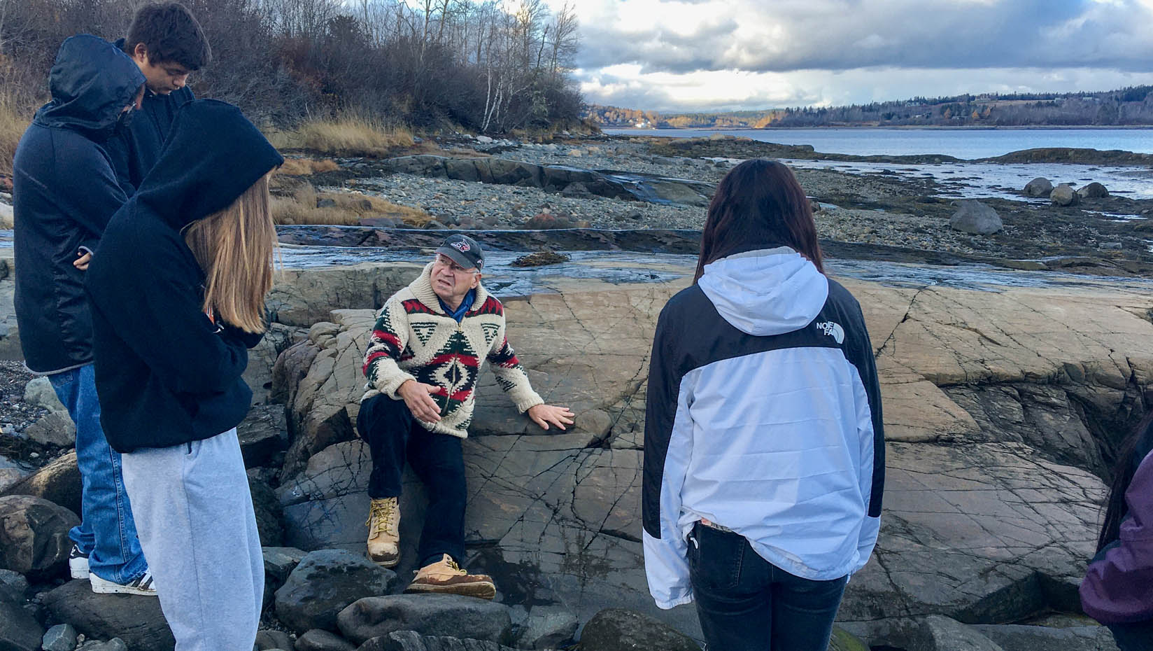 People standing on the coastline of Maine