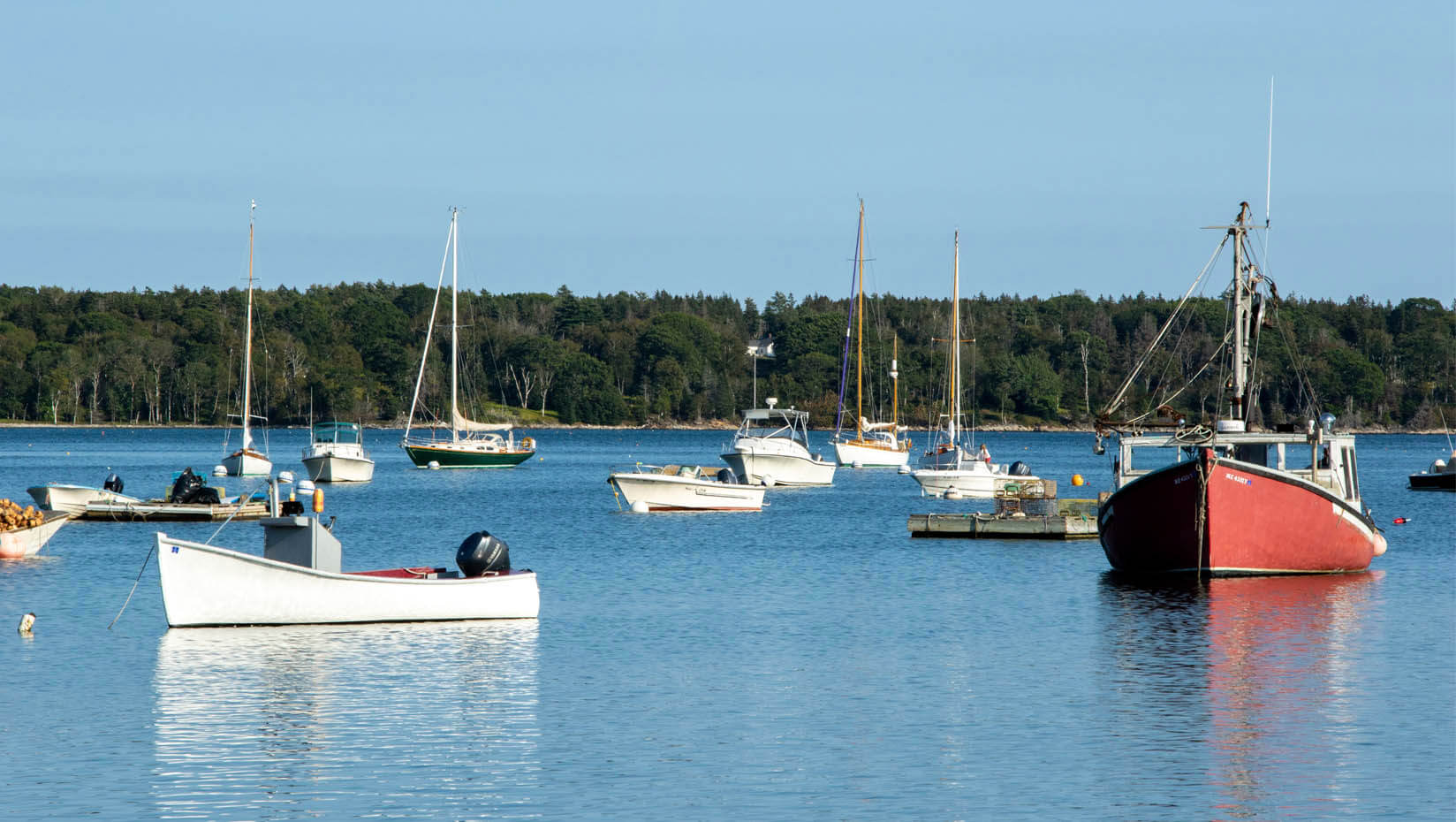 A photo of boats in a harbor on the coast of Maine