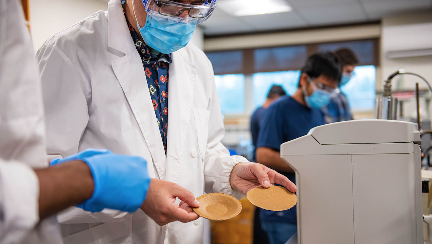 A photo of a researcher holding a nanocellulose container