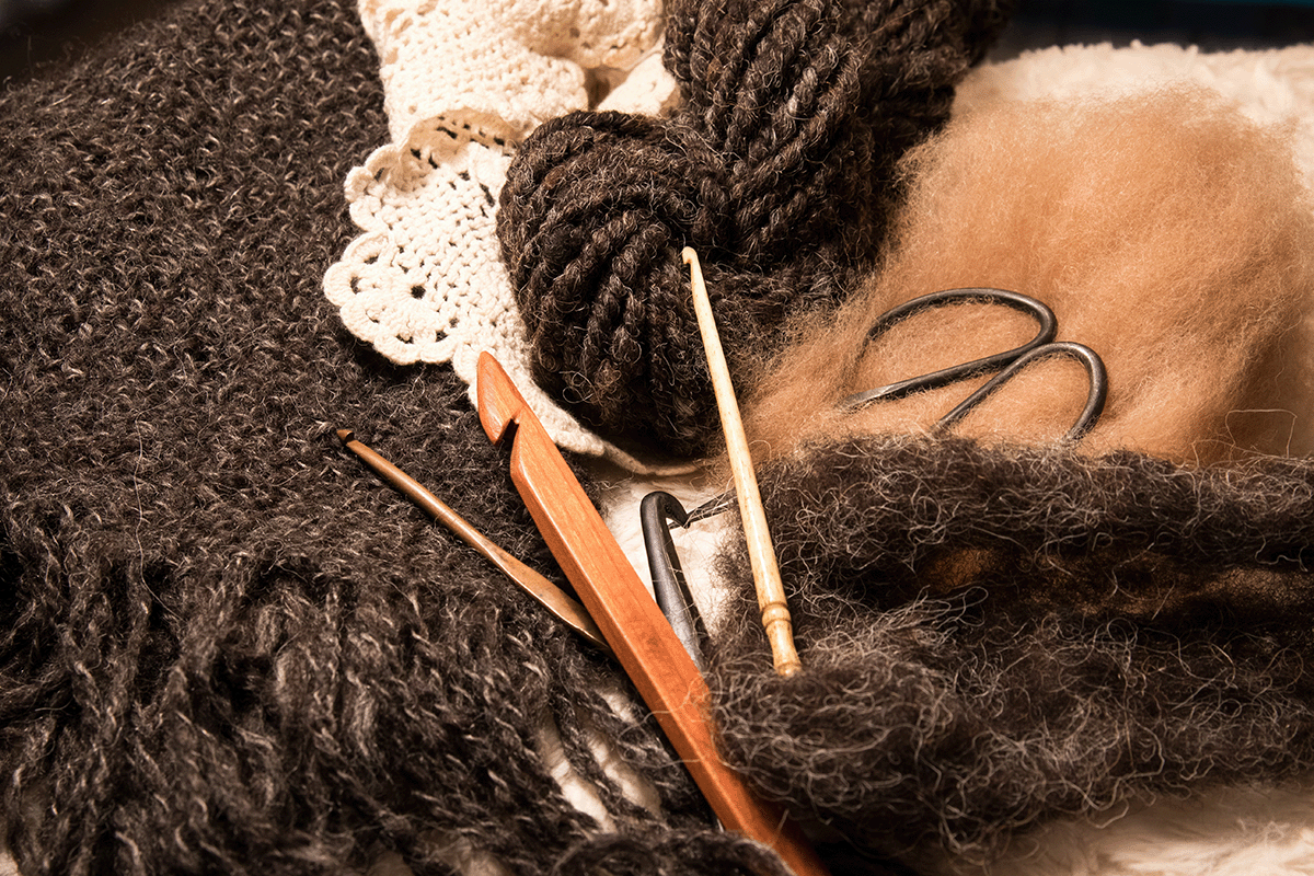 a decorative pile of fibers and crocheting supplies