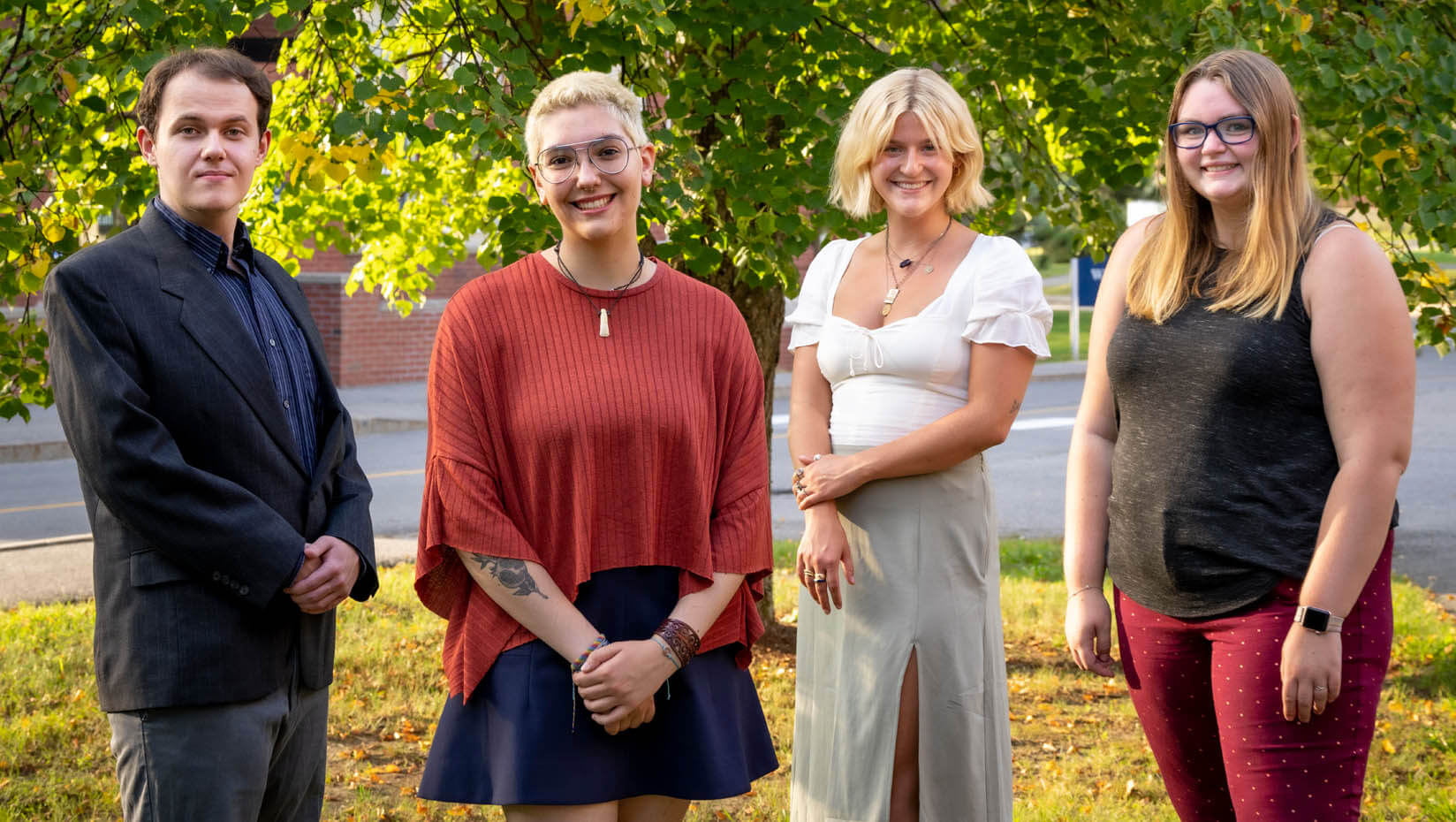 A photo of four research fellows standing outside