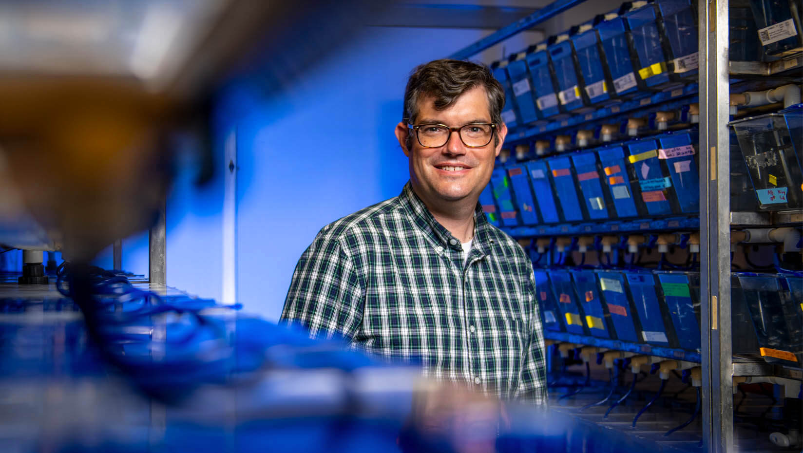 A photo of Ben King in the zebrafish facility