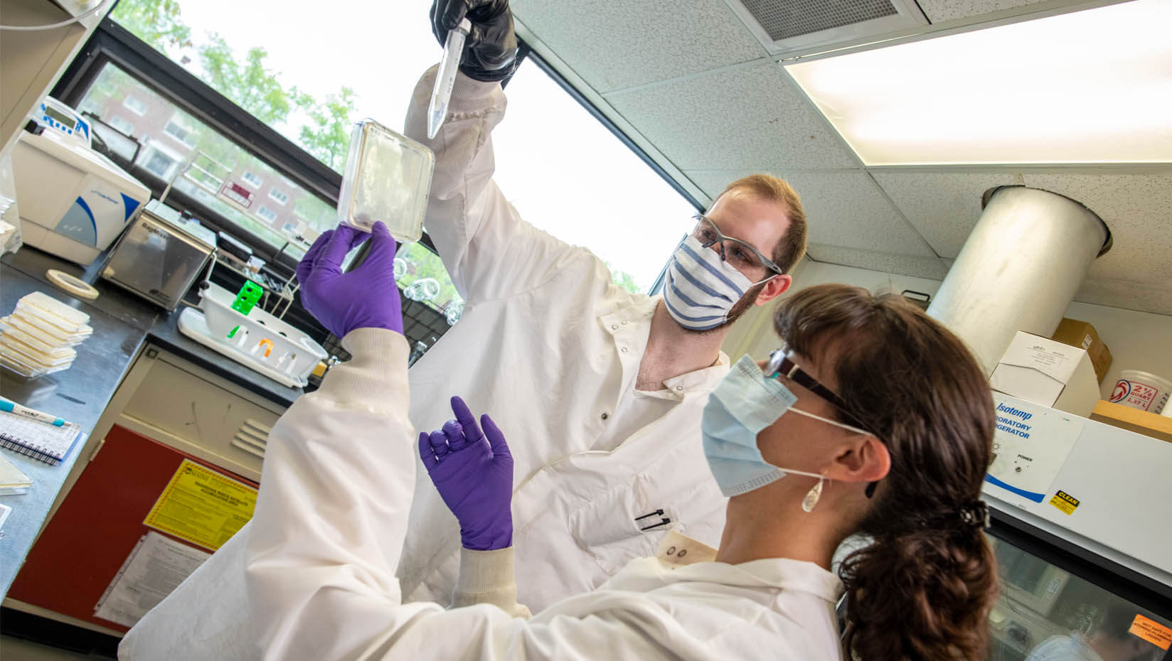 A photo of two people in a lab