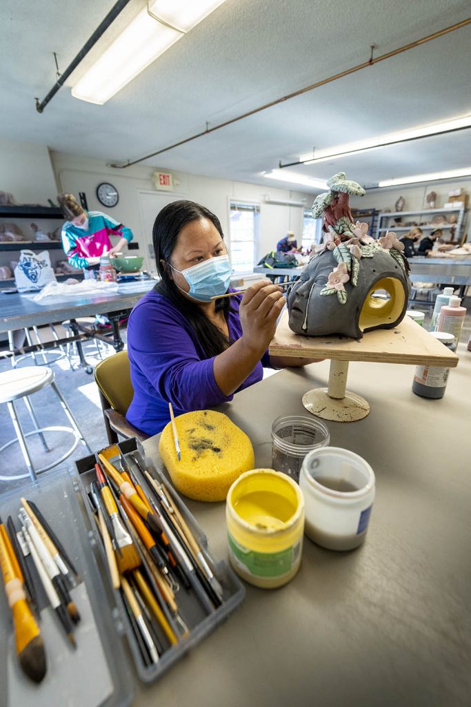 A photo of Chanthu Millay in a ceramics studio