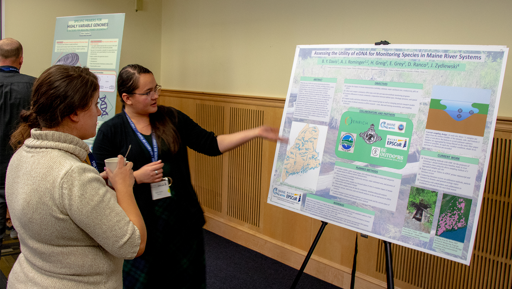 A photo of Beth Davis presenting a poster.