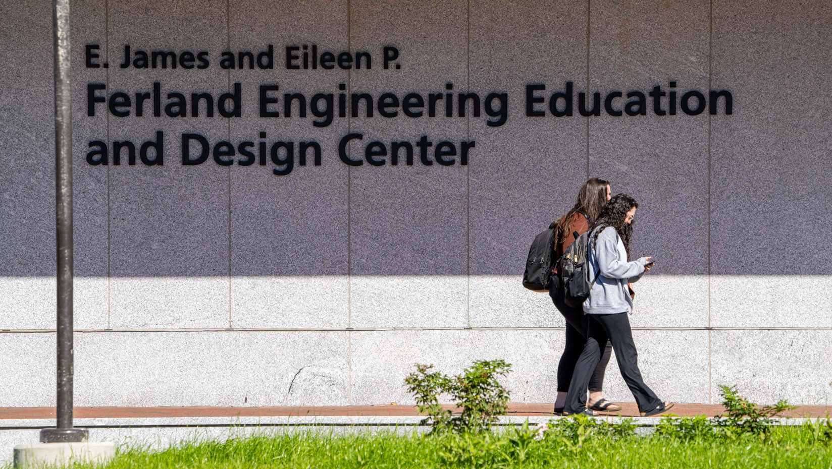 A photo of students walking in front of UMaine's Ferland EEDC building on campus