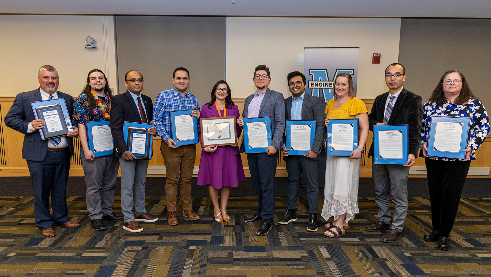 A group of people holding certificates