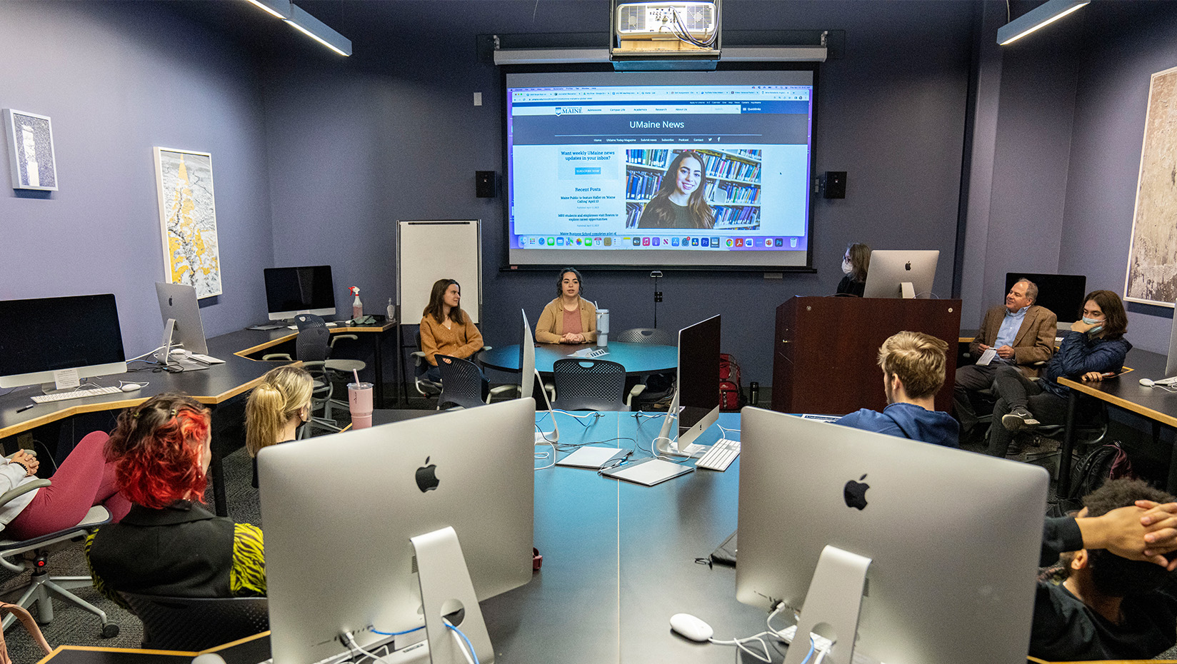 A group of students watching a presentation in a classroom