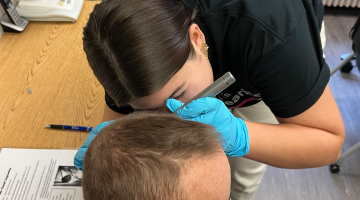 A photo of a hearing test being administered at the Special Olympics