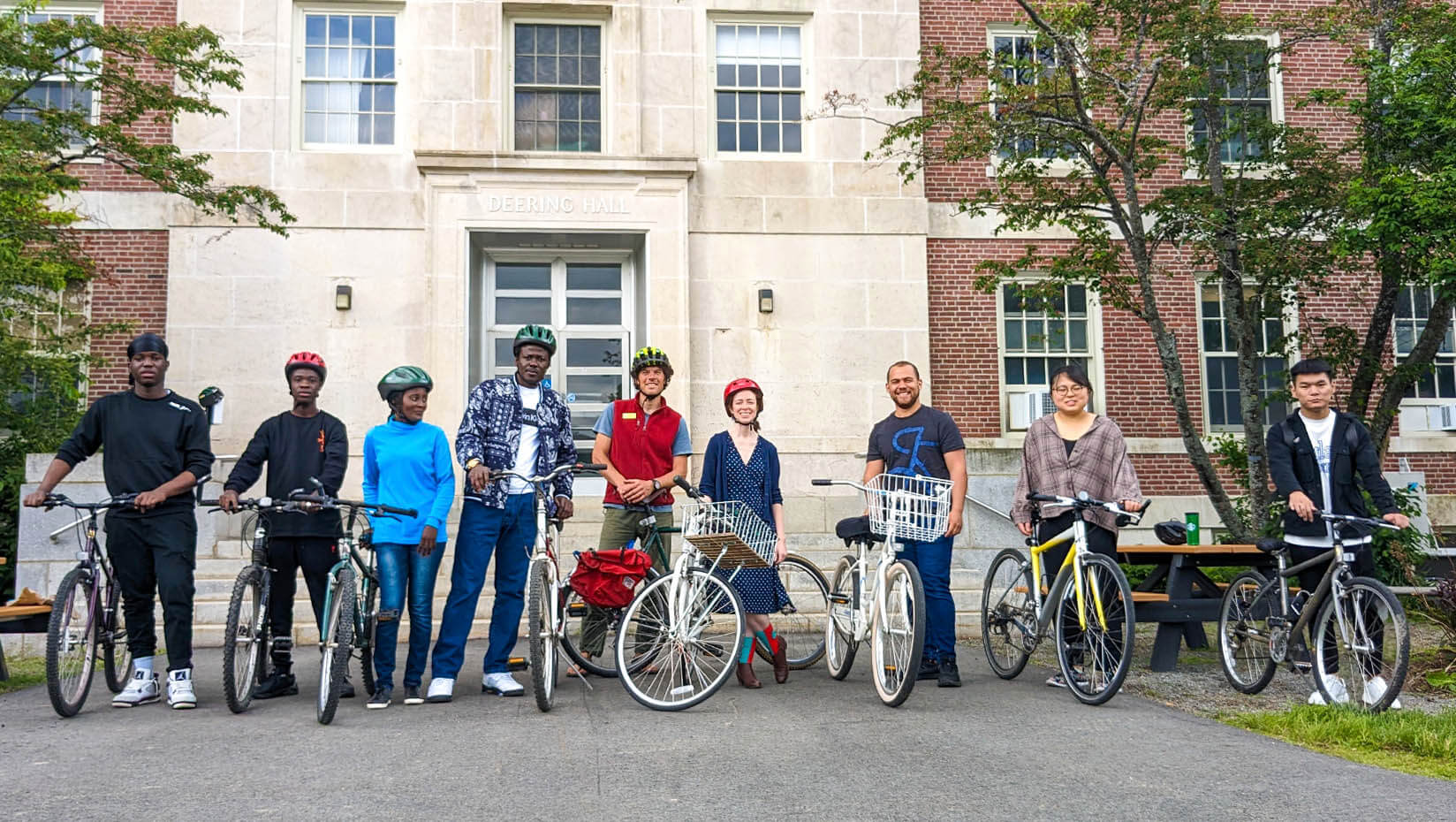 A photo of IEI students standing outside a building with bikes
