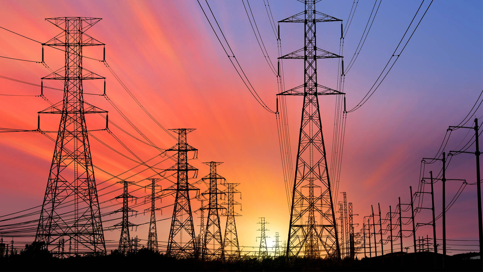 A photo of an electrical grid at sunset