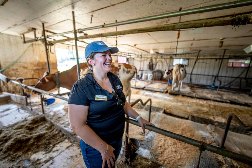 A photo of a woman standing in a barn