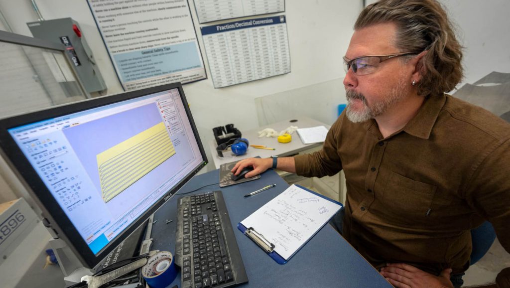 A photo of a person looking at a computer screen