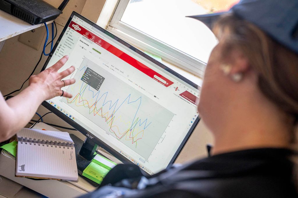 A photo of two people looking at a computer screen