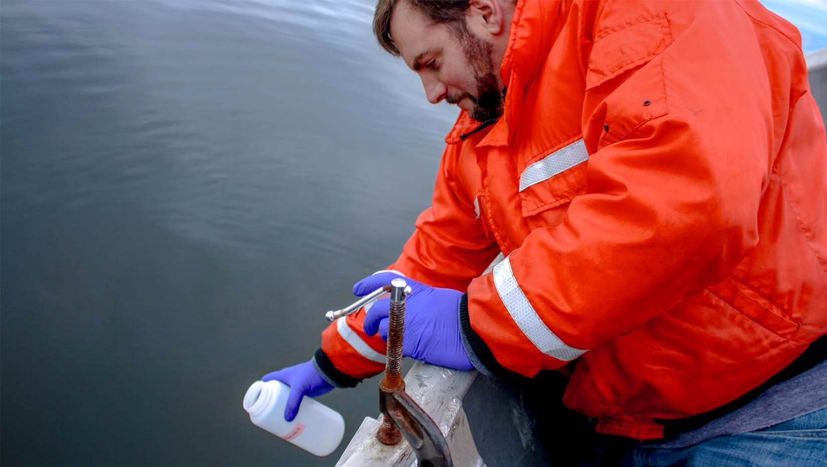 A photo of a person taking a water sample