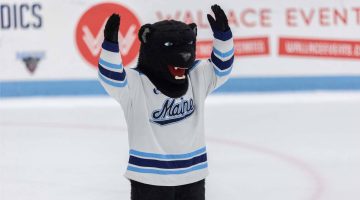 A photo of UMaine's mascot Bananas T. Bear on the ice at a hockey game