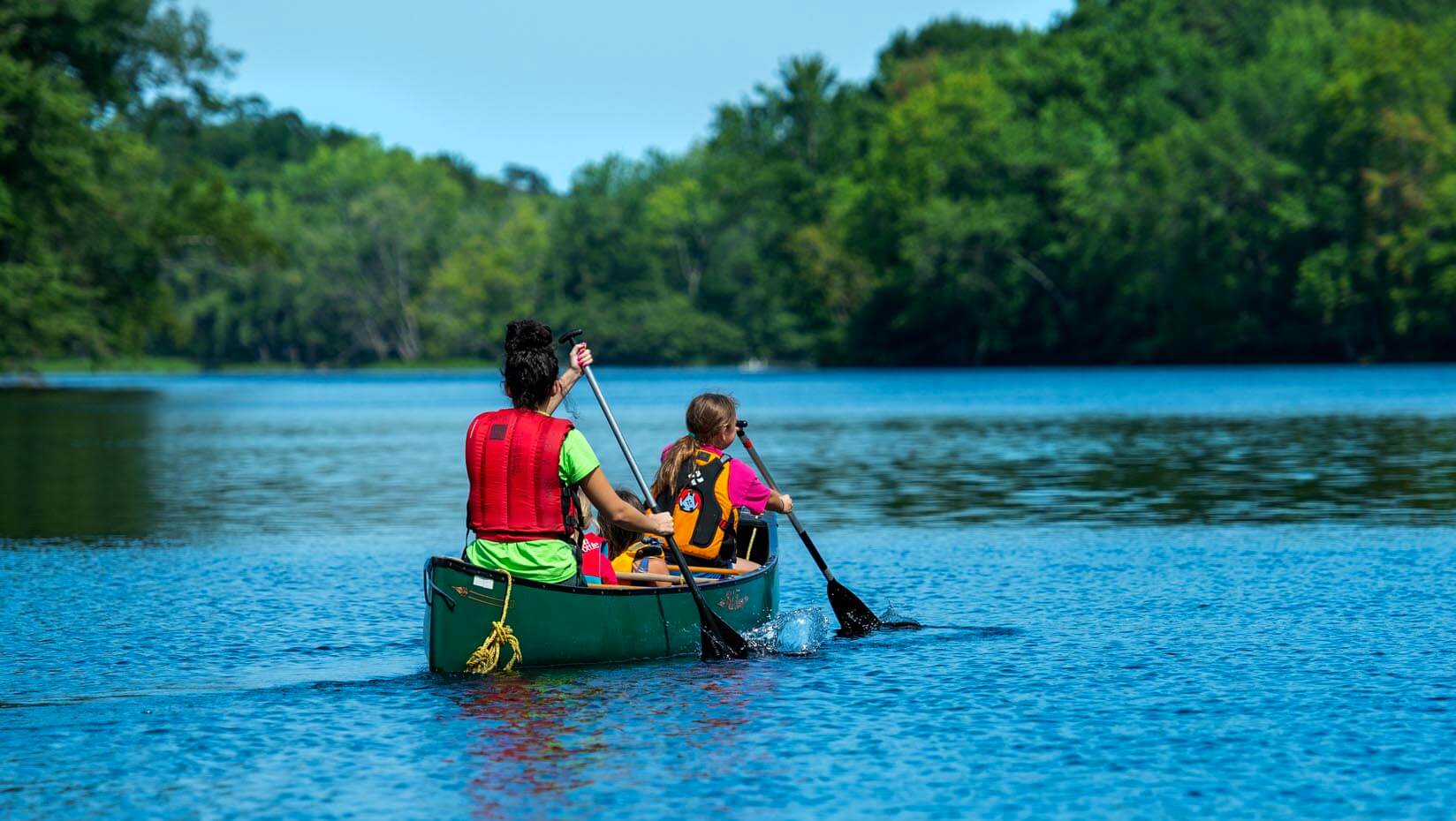 A photo of two people in a canoe on a river