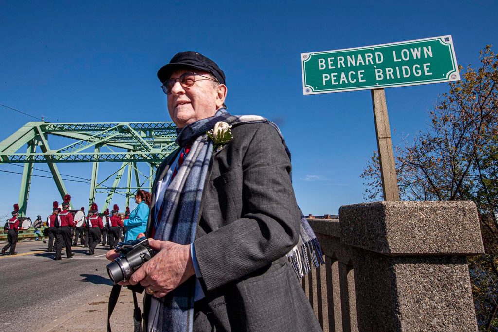 A photo of Bernard Lown in front of a bridge named for him