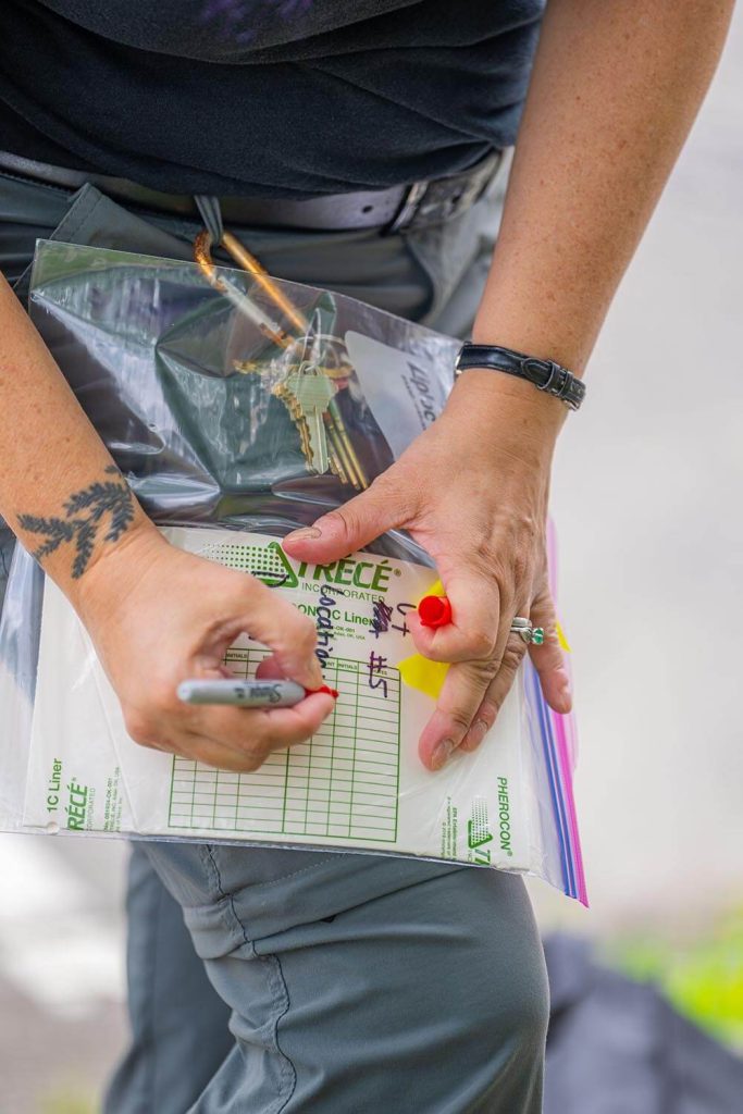 A photo of a person writing on a plastic bag