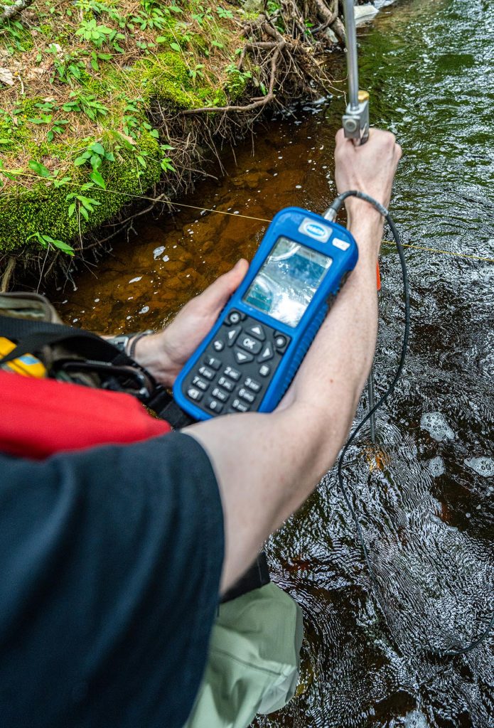 A photo of someone holding a device in a stream