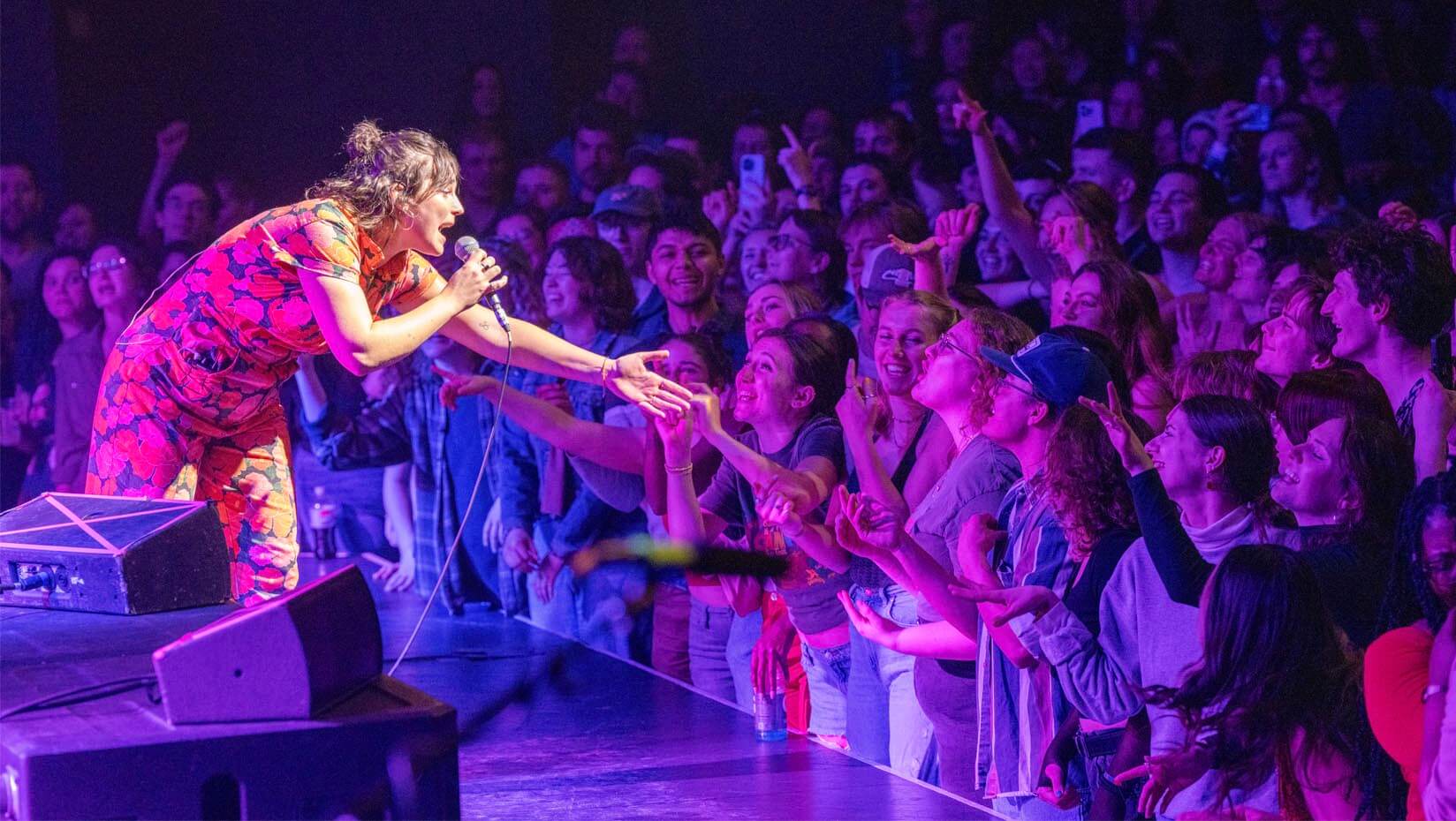 A photo of a person performing on a stage in the Collins Center for the Arts