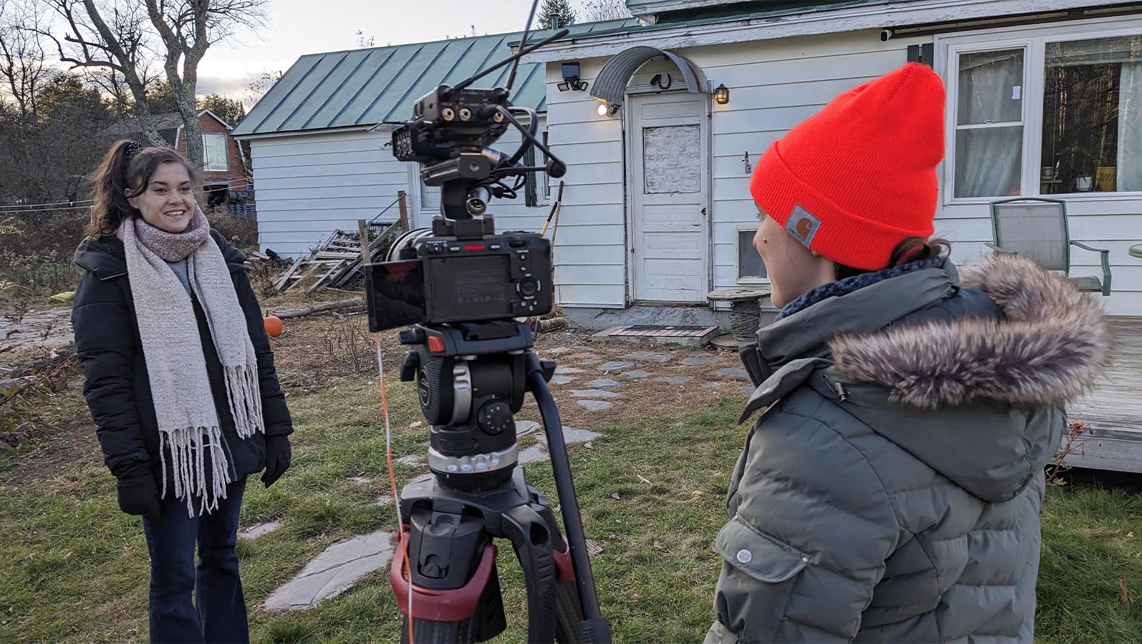 A photo of a person filming an interview with another person.