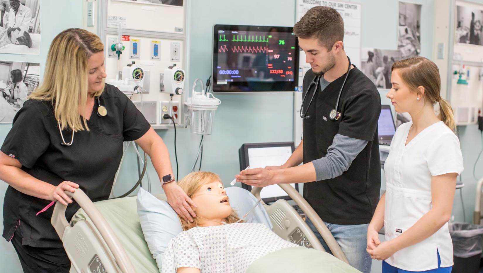 A photo of nursing students working in a nursing lab