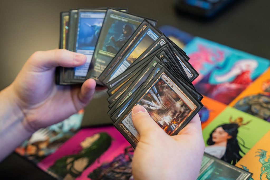 Hands holding Magic the Gathering cards