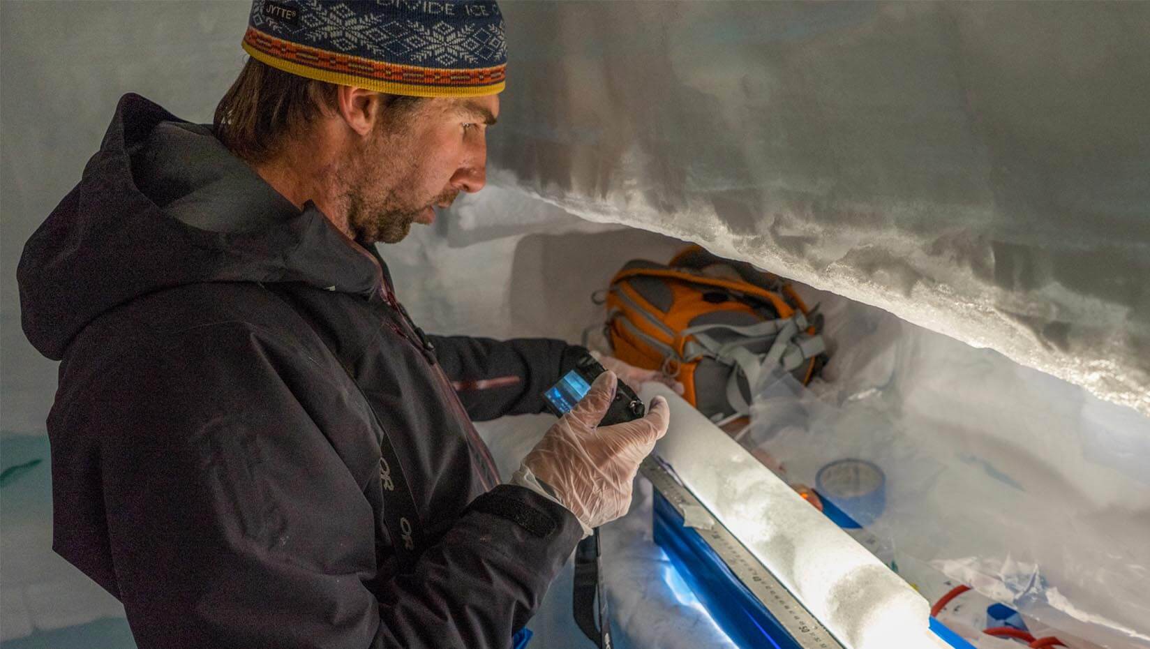 A photo of a person inspecting an ice core