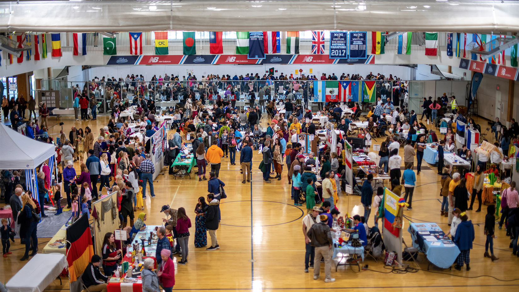 A photo of a large crowd gathered in a gymnasium.