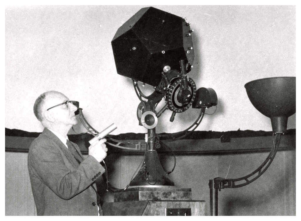 A photo of a man with astronomy equipment