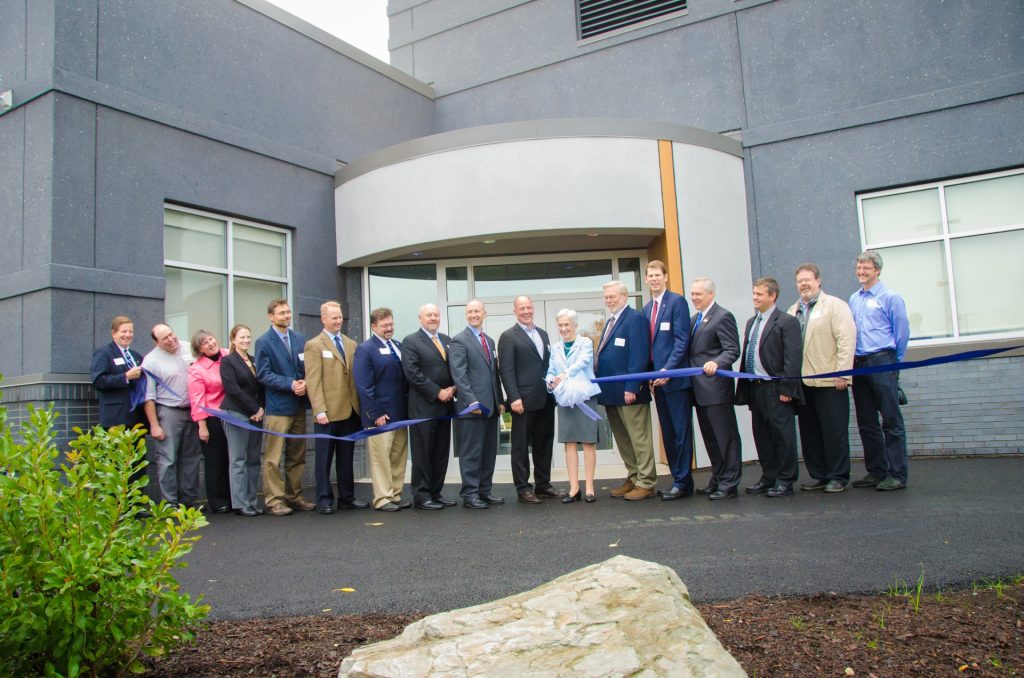 A photo of a group of people at the planetarium ribbon cutting