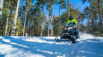 A photo of a man on a snowmobile