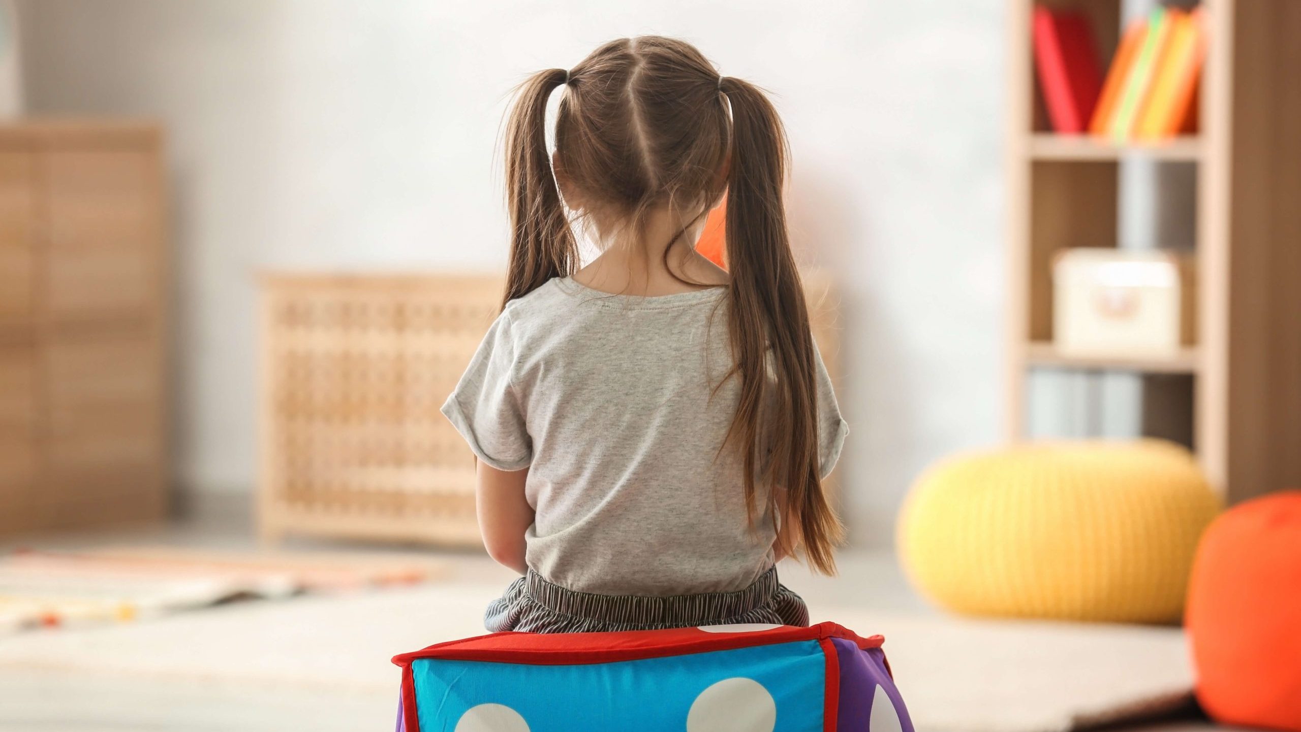 A stock image of a girl sitting on a box