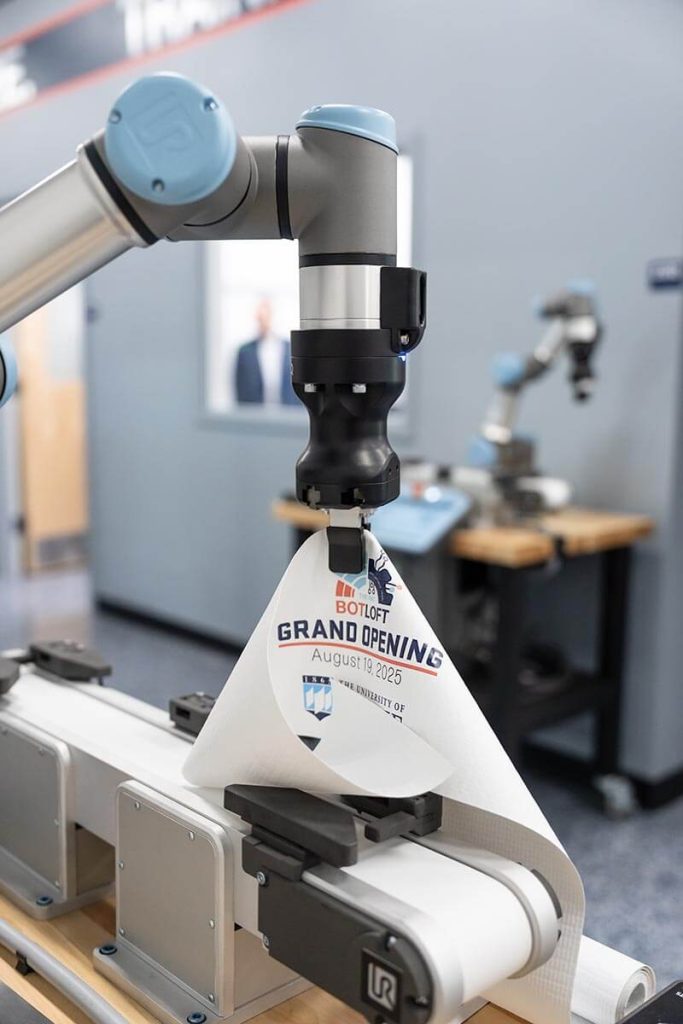 A photo of a robot holding the ceremony ribbon
