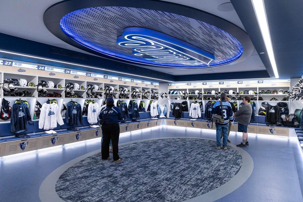 A photo of people touring the updated locker rooms in Alfond Arena