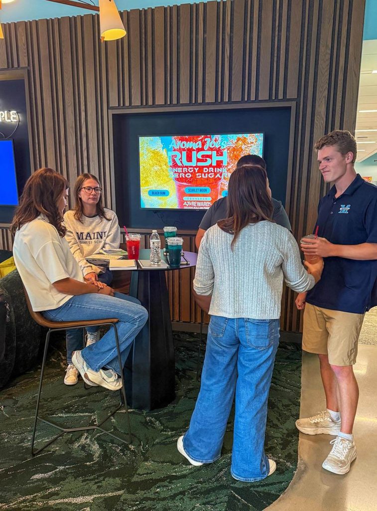 An image of students at an Aroma Joe's location