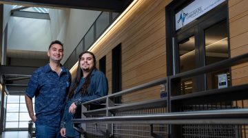 A photo of two people standing outside a lab