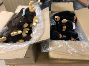 stuffed moose and black bears in a box