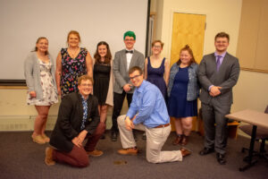 Picture of NRHH founders. 9 people total in professional attire smiling for group photo!