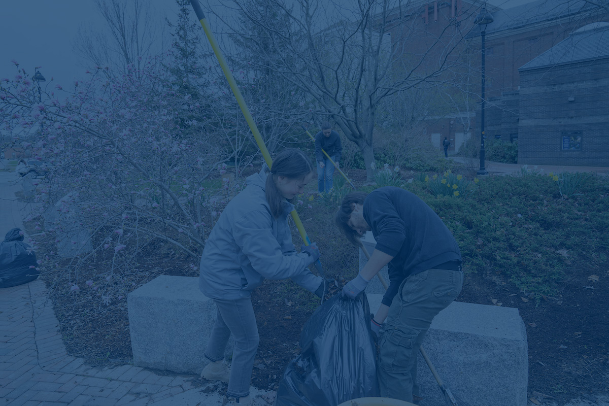 A photo of students doing campus cleanup with a blue overlay. Link to Black Bear Exchange website
