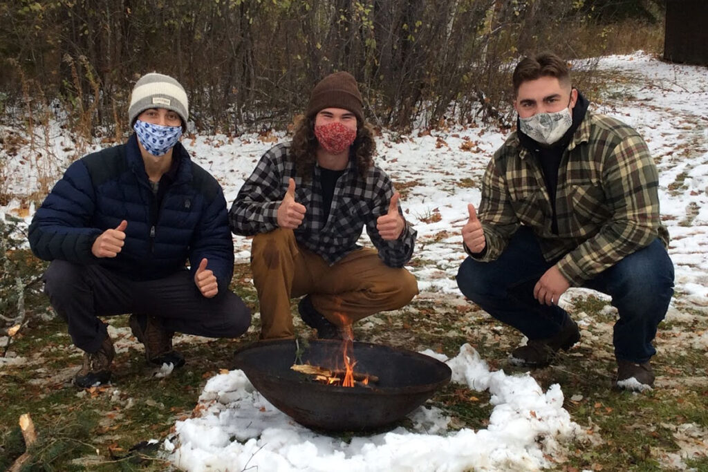 three men making a fire