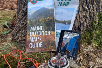 Photo of trail maps and compass