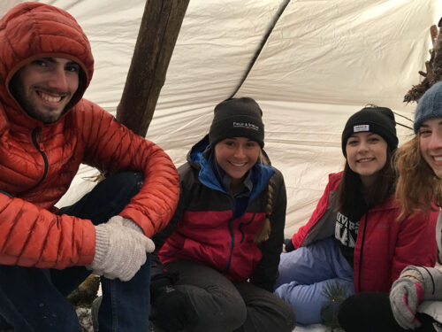 Hikers huddled in winter shelter