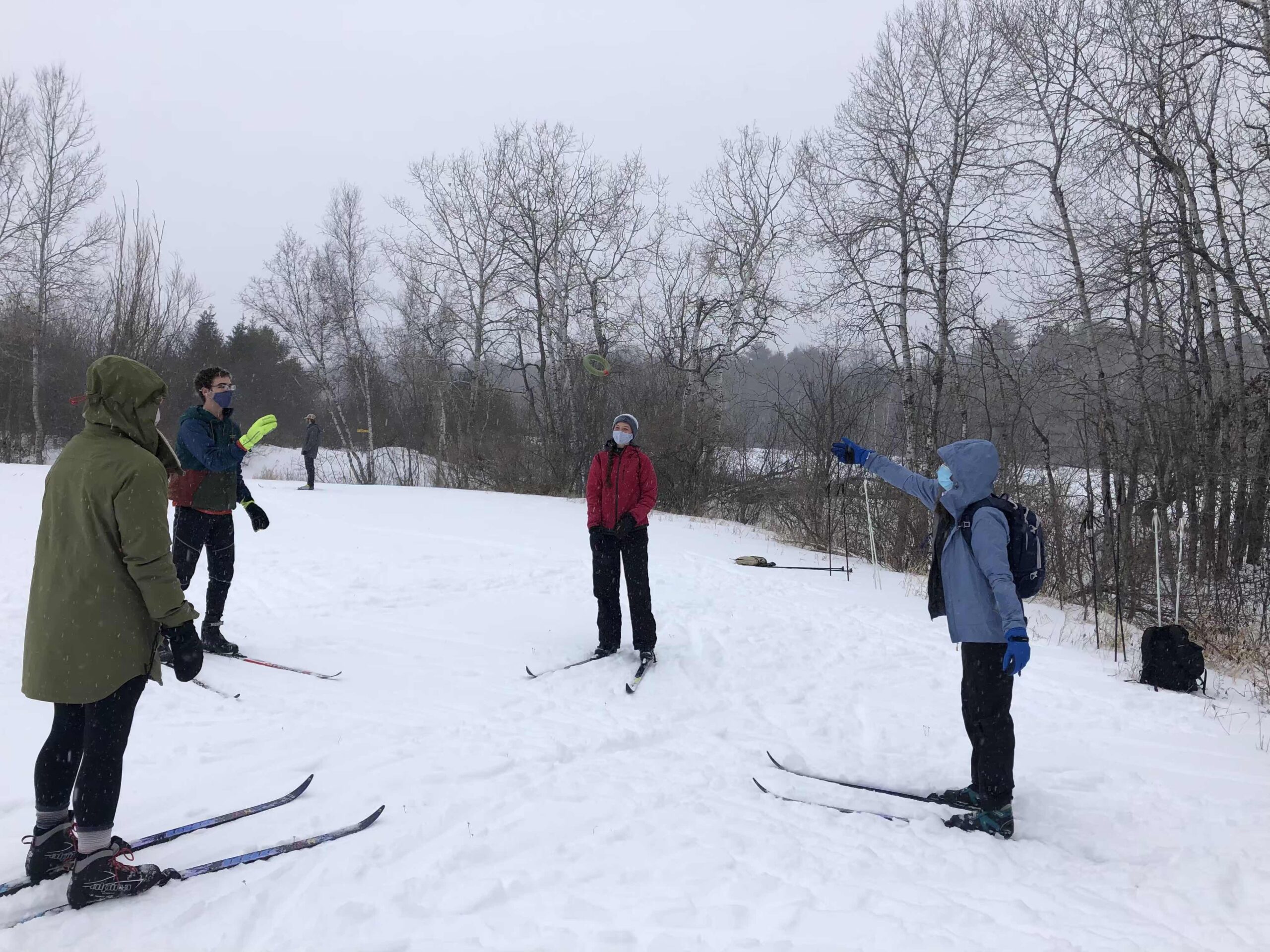 students playing a ring toss game on cross country skis