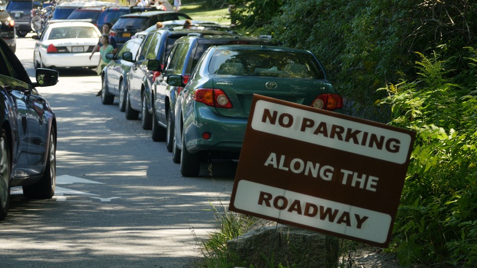Traffic sign reading, "No Parking Along the Roadway."